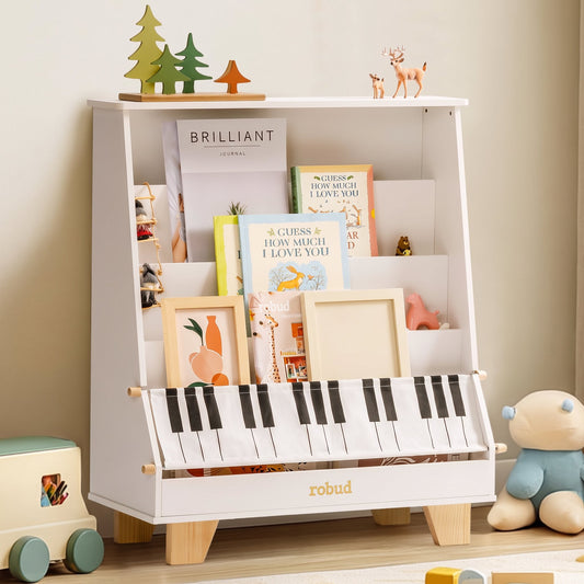 ROBUD wooden kids bookshelf (white) in a room with wooden toys on the floor, showing the tiered front-facing book display and the piano-key fabric storage pocket