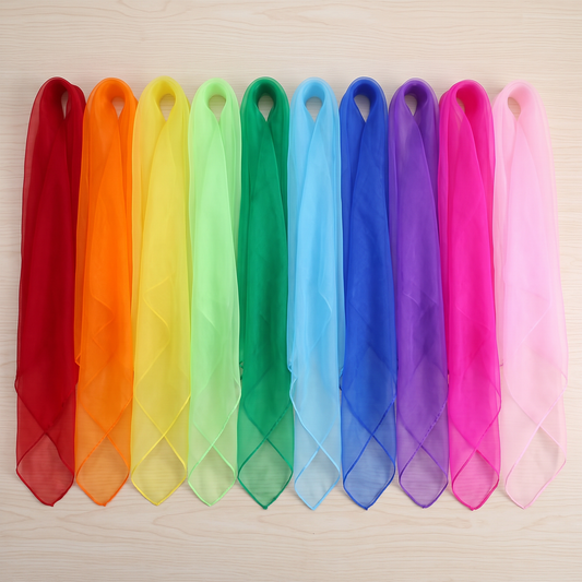 Ten solid-color 60cm play silks laid flat side by side, red through pink, no overlap
