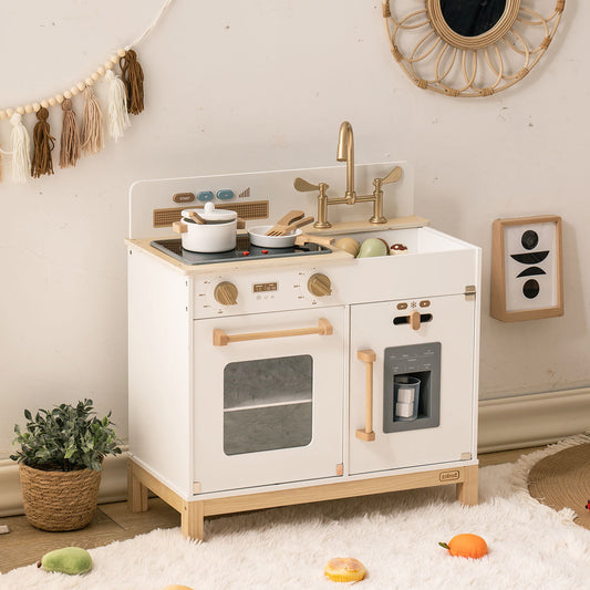White wooden play kitchen close-up in a home setting showing the stovetop, sink, and gold hardware