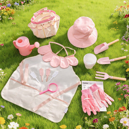 Light pink children's gardening set flat-lay on grass: tote bag, hat, apron, gloves, watering can, tools