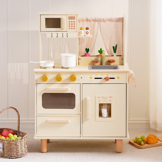 Cream wooden play kitchen with oven, sink, and hanging pot rail, front view in a bright playroom