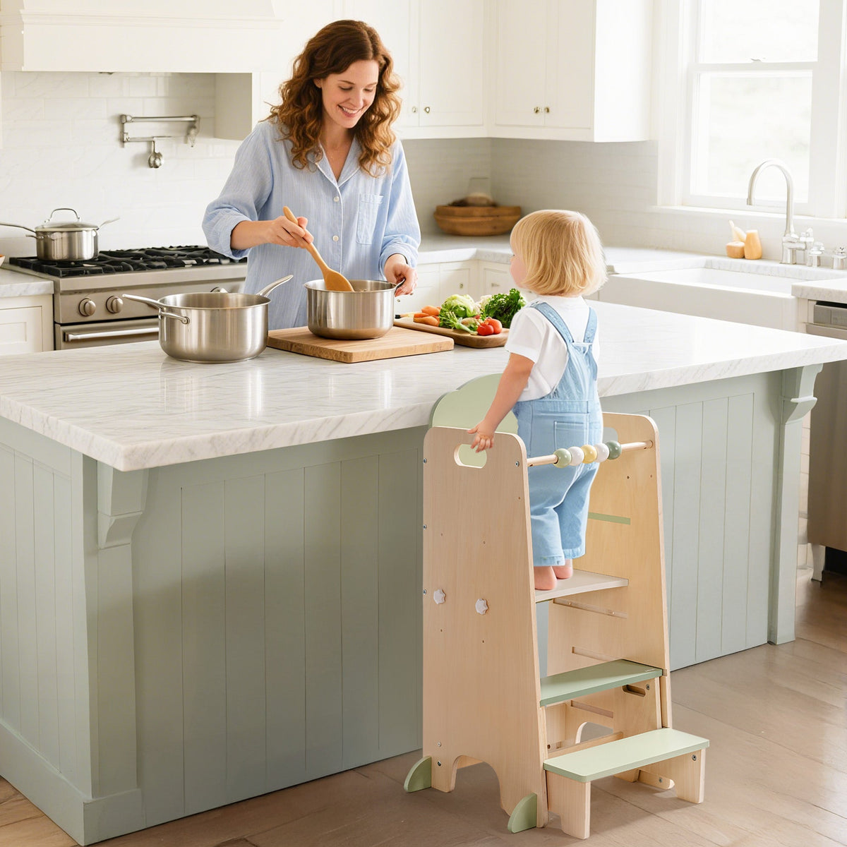 ROBUD Toddler Standing Tower lifestyle view with mother cooking and toddler helping at kitchen counter using the wooden learning tower