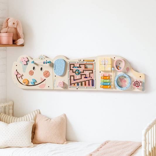 Cream wooden elephant-shaped activity busy board, front view showing bead maze, gears, and abacus