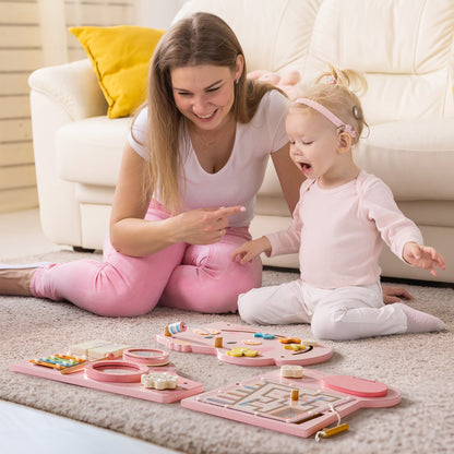 Mother and toddler playing on a floor mat near the pink elephant activity busy board