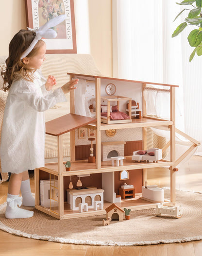 Girl reaching toward the open bohemian wooden dollhouse in a living room, three-quarter view