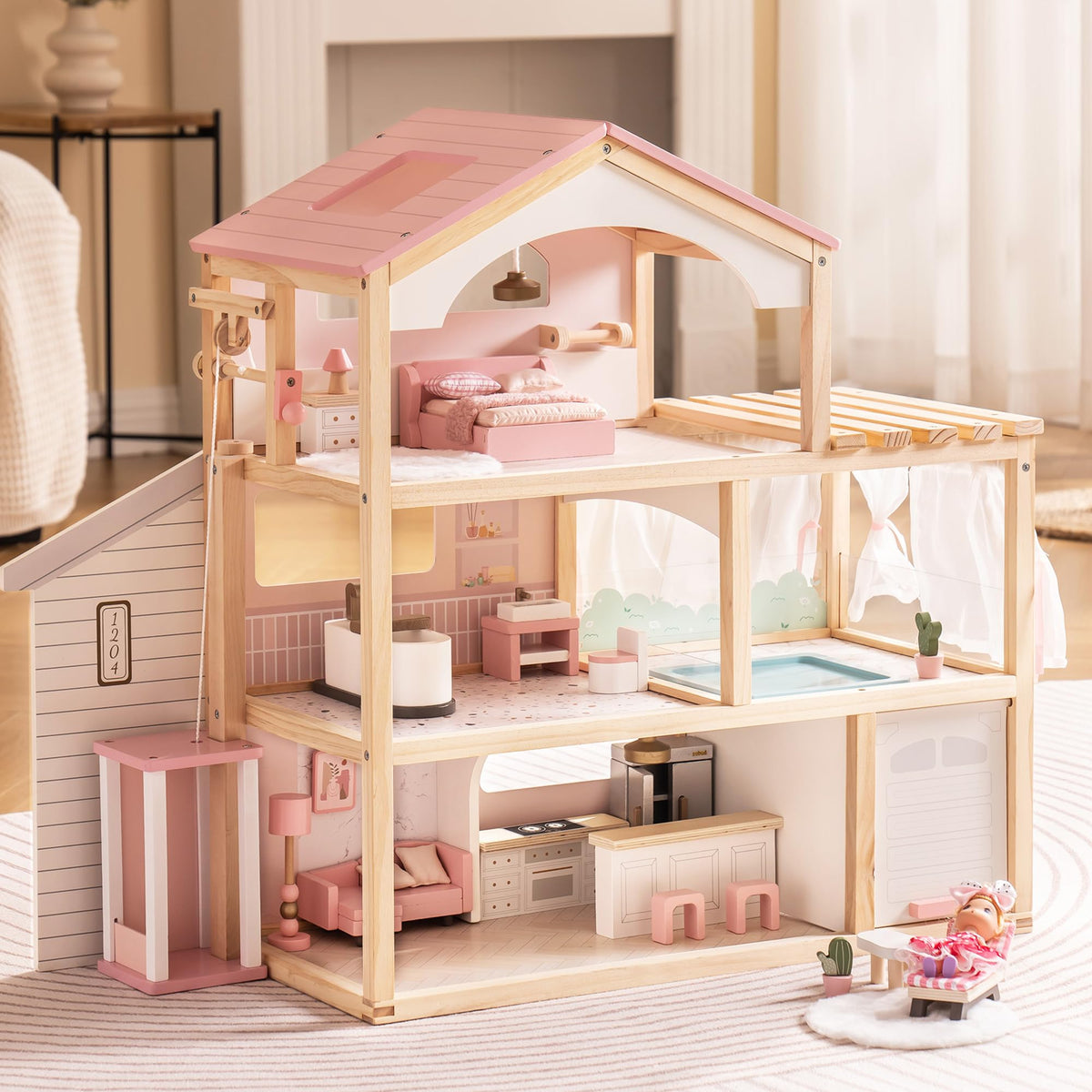 Three-story wooden dollhouse with pink roof and natural wood frame showing furnished interior rooms