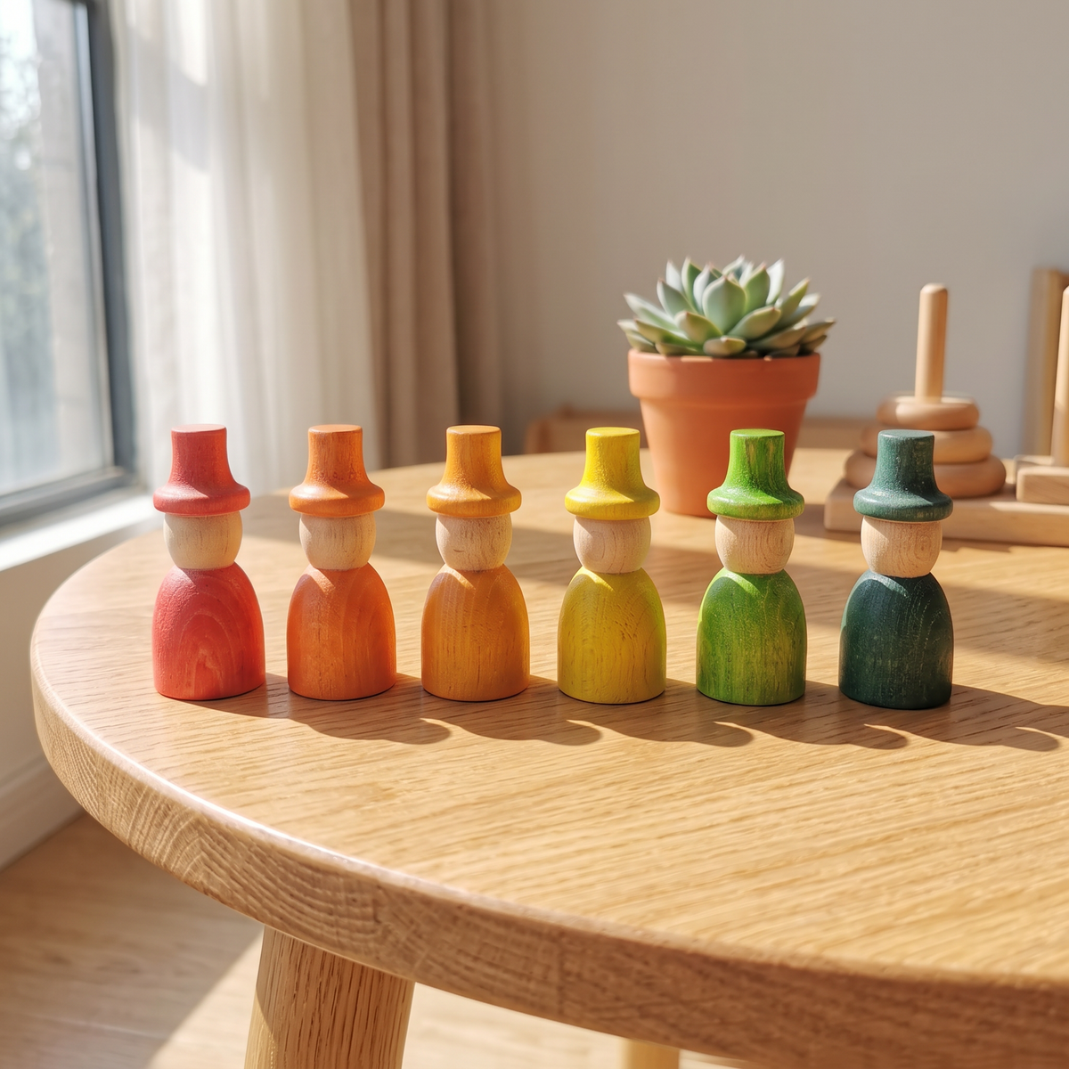 6 rainbow-colored wizard peg dolls in a row on a wood table (rainbow 6)