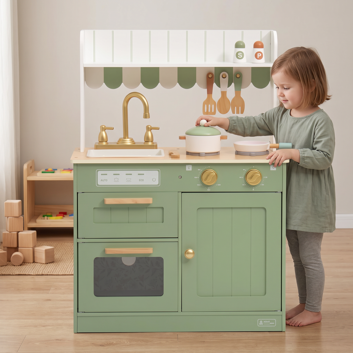 Sage green wooden play kitchen in a Montessori playroom, a child about 4 years old lifting the pot lid
