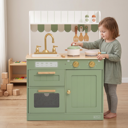 Sage green wooden play kitchen in a Montessori playroom, a child about 4 years old lifting the pot lid