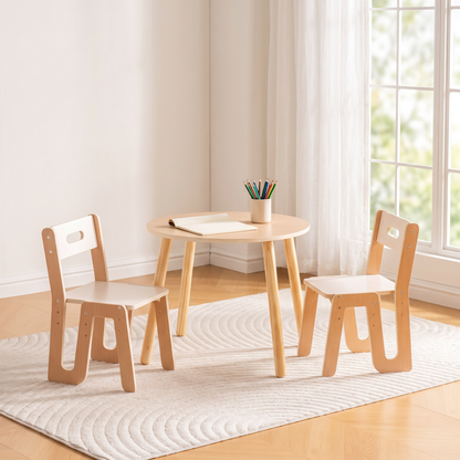 Natural beech and white round kids table and two chairs in a sunny reading nook, notepad and colored pencils on the table, no people