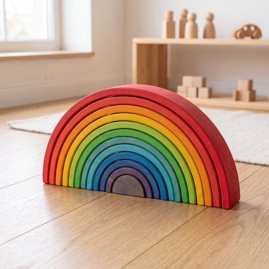 Lime wood rainbow arch stacker assembled on a wood floor in a natural-wood Montessori playroom
